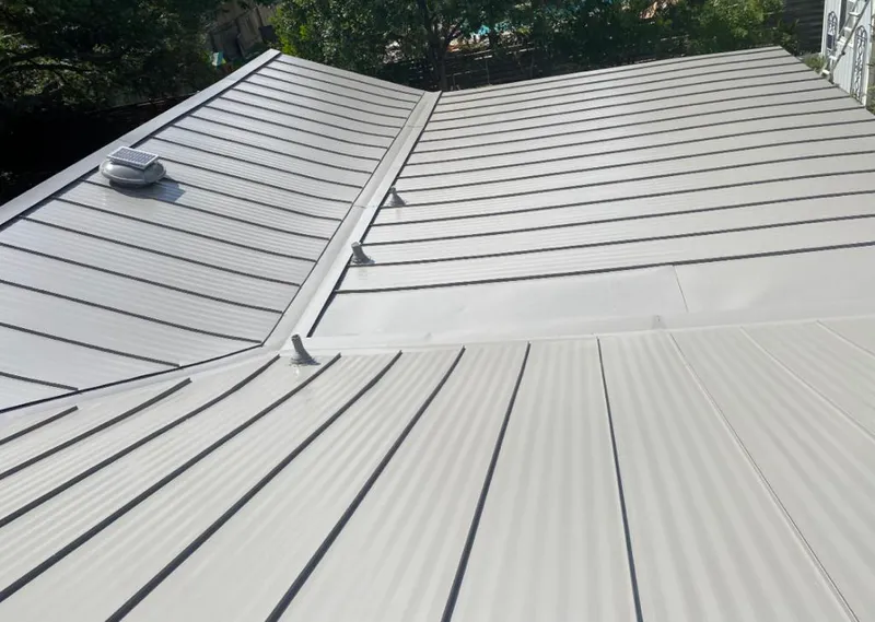 Solar attic fan installed on a metal roof for Roof Ventilation in Norwich